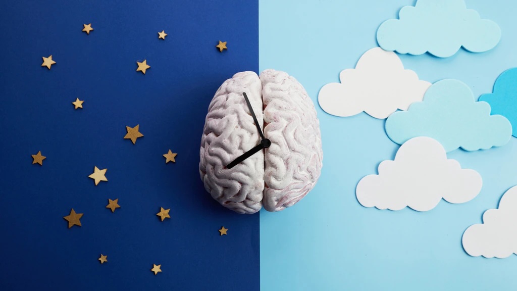A clock with a brain design on its face, surrounded by fluffy clouds.